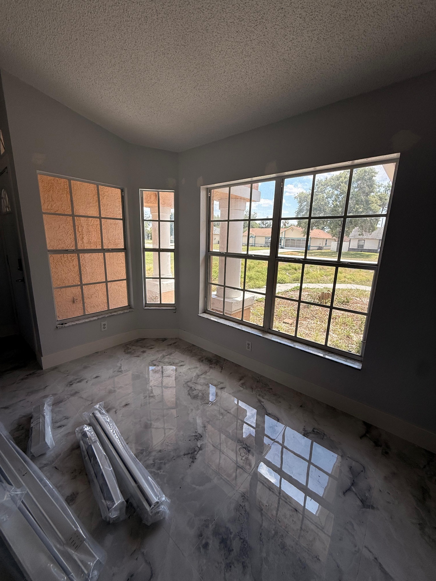 Before and after: Tampa living room window with new white roller shades